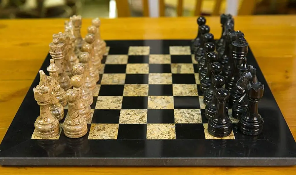 A black and fossil marble chess set